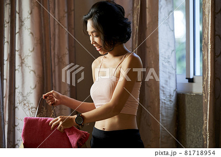 Woman Putting Soft Towel in Bag Woman Putting Soft Towel in Bag 81718954