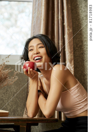 Cheerful Woman Eating Sweet Apple Cheerful Woman Eating Sweet Apple 81718983