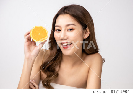 Beautiful Young Asian Woman short hair  with Clean Fresh Skin. Face care, Facial treatment, Cosmetology, beauty and healthy skin and cosmetic ideas concept.pretty woman holding half of orange and 81719904