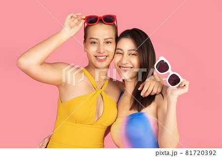 Beautiful Sexy asian woman in bikini and smiling standing  on pink background isolated .Summer vocation happy trip concept. 81720392