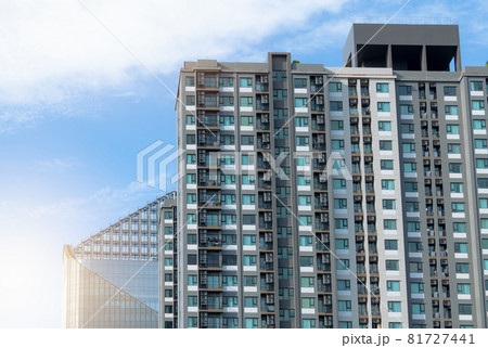 Apartment building. Exterior of skyscraper building. Transparent glass windows of apartment. Back view of apartment building installed air conditioner. Residential building. Real estate business. 81727441