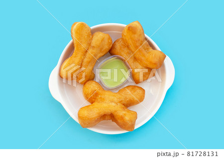 Deep-fried dough sticks or chinese bread sticks on blue background. 81728131
