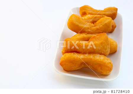 Deep-fried dough sticks or chinese bread sticks on white background. Deep-fried dough sticks or chinese bread sticks on white background. 81728410
