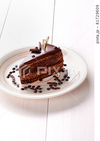 Small cake with different stuffing on a white plate. White wooden table. Small cake with different stuffing on a white plate. White wooden table. 81729609
