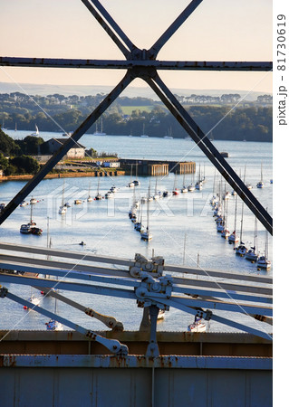 Construction of Royal Albert Bridge (railway) against sailboats on Tamar river between Devon and Cornwall, Plymouth area, England, UK Construction of Royal Albert Bridge (railway) against sailboats on Tamar river between Devon and Cornwall, Plymouth area, England, UK 81730619