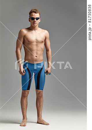 Portrait of a swimmer in a cap and mask, half-length portrait, young athlete swimmer wearing a cap and mask for swimming, copies of space, gray background 81730836
