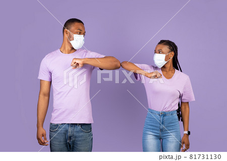 African American couple in mask doing elbow bumping 81731130