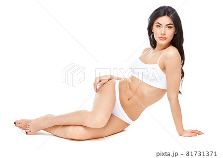 Fitness young woman with a beautiful body sitting on white background Fitness young woman with a beautiful body sitting on white background 81731371