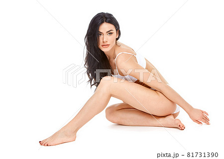 Fitness young woman with a beautiful body sitting on white background Fitness young woman with a beautiful body sitting on white background 81731390