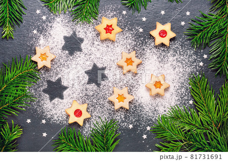 christmas linzer cookies with raspberry jam on slate table 81731691