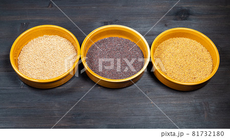 white, black, yellow mustard seeds in ceramic bowls on black wooden table white, black, yellow mustard seeds in ceramic bowls on black wooden table 81732180