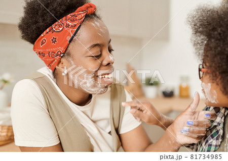 Laughing young African female playing with her cute son 81734985