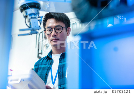 Asian male Engineers Maintenance Robot Arm at Lab. he are in a High Tech Research Laboratory with Modern Equipment. Technology and Innovation Concept.. 81735121