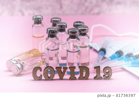 Medical ampoules and mask. Syringes and ampoules. Pink background. Injections and medications. 81736397