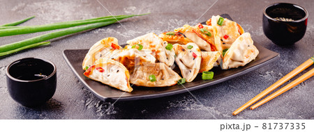 Fried dumplings served with green onions. Fried dumplings served with green onions. 81737335