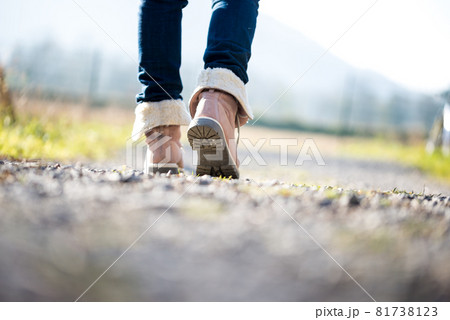 Woman walking along a rural path 81738123