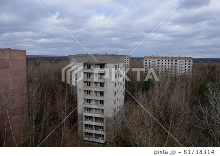 Abandoned panel houses among leafless trees in Pripyat. Beautiful cloudy sky over the city. Post-Soviet architecture. Abandoned panel houses among leafless trees in Pripyat. Beautiful cloudy sky over the city. Post-Soviet architecture. 81738314