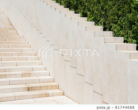 Ornamental garden with trimmed bushes and beige staircase. Geometrical background with shrubs and architectural construction. Diagonal perspective. Ornamental garden with trimmed bushes and beige staircase. Geometrical background with shrubs and architectural construction. Diagonal perspective. 81744688