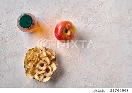 Apples chips on plate, apple fruit and bottle with juice Apples chips on plate, apple fruit and bottle with juice 81746943