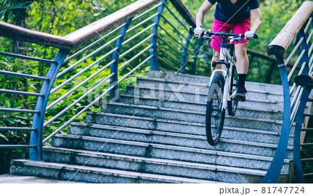 Woman freerider riding down stairs. Sports extreme and active lifestyle Woman freerider riding down stairs. Sports extreme and active lifestyle 81747724