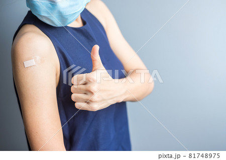 Happy woman showing thumb with bandage after receiving covid 19 vaccine. Vaccination, herd immunity, side effect, efficiency, vaccine passport and Coronavirus pandemic Happy woman showing thumb with bandage after receiving covid 19 vaccine. Vaccination, herd immunity, side effect, efficiency, vaccine passport and Coronavirus pandemic 81748975