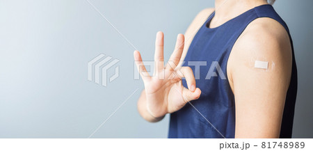 Happy woman showing OK sign with bandage after receiving covid 19 vaccine. Vaccination, herd immunity, side effect, efficiency, vaccine passport and Coronavirus pandemic Happy woman showing OK sign with bandage after receiving covid 19 vaccine. Vaccination, herd immunity, side effect, efficiency, vaccine passport and Coronavirus pandemic 81748989