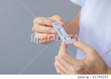 man holding Rapid Antigen Test kit with Negative result during swab COVID-19 testing. Coronavirus Self nasal or Home test, Lockdown and Home Isolation concept man holding Rapid Antigen Test kit with Negative result during swab COVID-19 testing. Coronavirus Self nasal or Home test, Lockdown and Home Isolation concept 81749297
