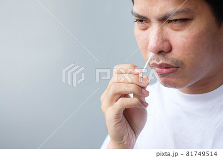 man swab COVID-19 testing by Rapid Antigen Test kit. Coronavirus Self nasal or Home test, Lockdown and Home Isolation concept 81749514