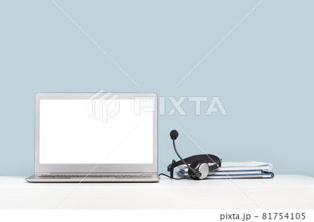 Laptop with headphones on white desk banner 81754105