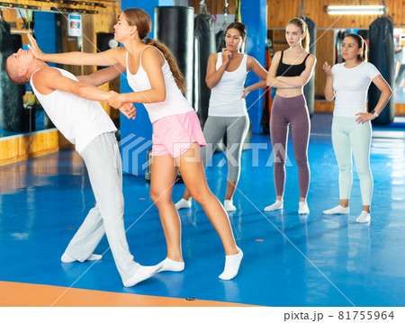 Young woman performing chin strike 81755964