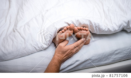 Baby reaching for feet, dimpled baby hands, triangle print blanket and  pants - a Royalty Free Stock Photo from Photocase