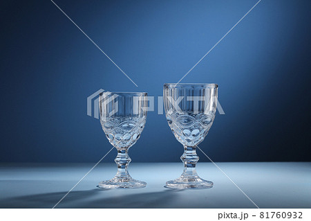 Different empty glasses on blue background 81760932