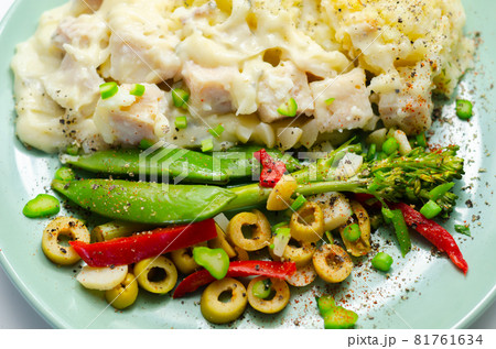 Tender pieces of smoked haddock and pollock in a creamy cheese sauce sat beneath buttery mash served with vegetables Tender pieces of smoked haddock and pollock in a creamy cheese sauce sat beneath buttery mash served with vegetables 81761634