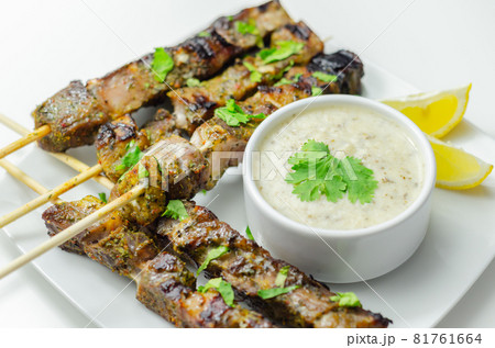 Pork shoulder kebabs with a lemon and herb rub and a garlic and mint yogurt sauce 81761664