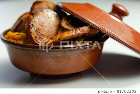 Traditional Polish dish called bigos made of sauerkraut, sausage and mushrooms, food served warm in a ceramic bowl 81762208