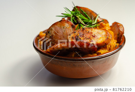 Traditional Polish dish called bigos made of sauerkraut, sausage and mushrooms, food served warm in a ceramic bowl 81762210