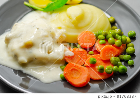 Cod Mornay, flaky cod with a creamy cheese sauce, with mashed potato, peas and carrots Cod Mornay, flaky cod with a creamy cheese sauce, with mashed potato, peas and carrots 81763337