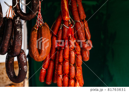 Typical Spanish sausages hanging on a village stall at the food market Typical Spanish sausages hanging on a village stall at the food market 81763631