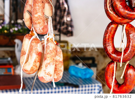 Typical Spanish sausages hanging on a village stall at the food market Typical Spanish sausages hanging on a village stall at the food market 81763632