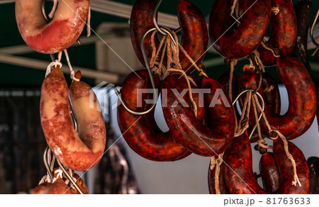 Typical Spanish sausages hanging on a village stall at the food market Typical Spanish sausages hanging on a village stall at the food market 81763633