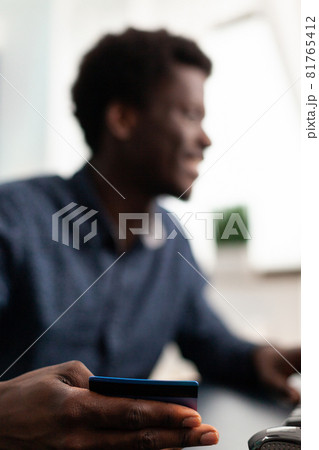 Customer holding debit credit card paying for purchases in web store 81765412