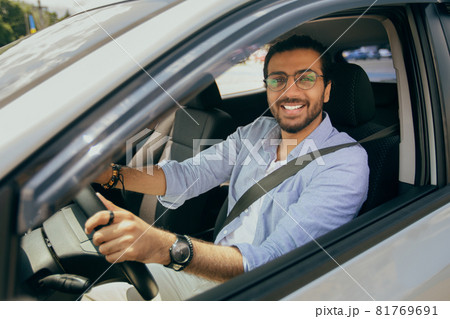 Stylish middle-eastern man driving nice auto, closeup photo Stylish middle-eastern man driving nice auto, closeup photo 81769691