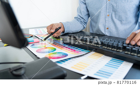 creative graphic designer choosing color scale for editing artwork while working in office. creative graphic designer choosing color scale for editing artwork while working in office. 81770116