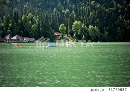 Catamarans on Lake Ritsa in Abkhazia. Walks on the water. Ecologically clean place in the mountains. 81770627