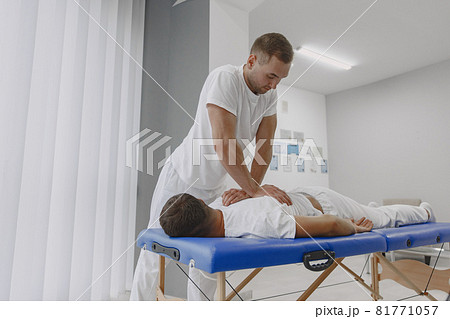 Male physiotherapist massaging man's back Male physiotherapist massaging man's back 81771057