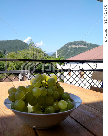 Grapes in a plate on the table in the house. View of the years. Abkhazia Grapes in a plate on the table in the house. View of the years. Abkhazia 81771550