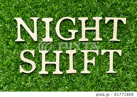 Wood letter in word night shift on green grass background Wood letter in word night shift on green grass background 81771868