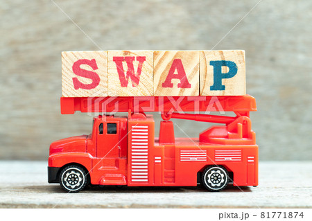 Fire ladder truck hold letter block in word swap on wood background 81771874
