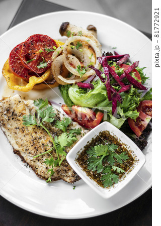 tilapia fish fillet with mixed salad and grilled vegetables 81772921