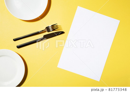 Mockup menu restaurant, fork and knife, empty plate on yellow background. Top view. Copy space Mockup menu restaurant, fork and knife, empty plate on yellow background. Top view. Copy space 81773348
